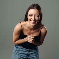 Thumbnail for Smiling woman in casual attire showcasing happiness and joy, perfect for lifestyle or fashion imagery.