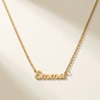 Thumbnail for Minimalist Name Necklace in gold laid flat, the name Emma in cursive cut-metal script | SKU: minimalistnn-gold