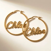 Thumbnail for Custom Name Hoop Earrings in Gold, studio packshot of the pair on a plain background | SKU: name-hoop-gold-30-mm