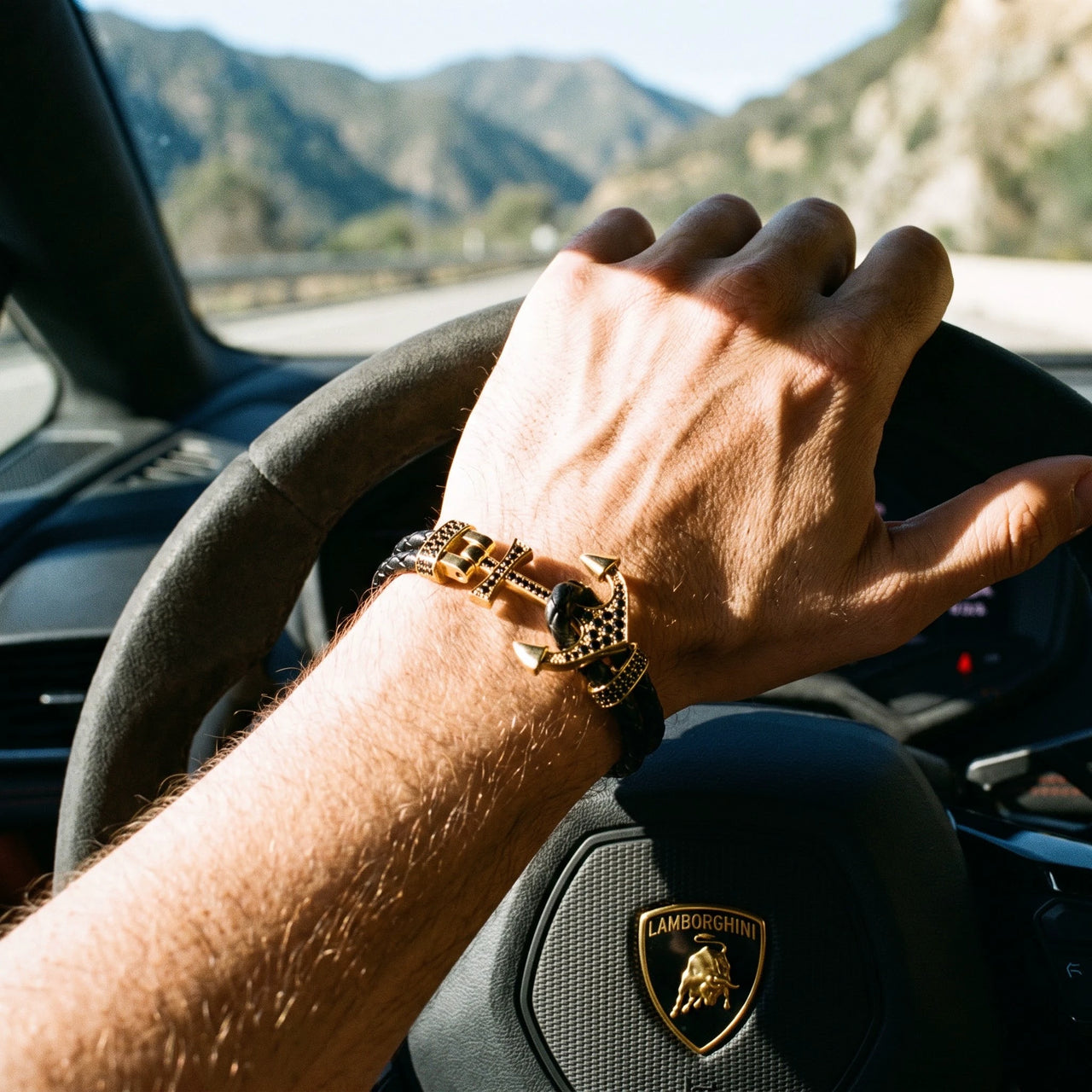 Gold Anchor – hand on a Lamborghini steering wheel | Brother & Sisters | SKU: 3621358-gold-XS-14-15, 3621358-gold-S-16-17, 3621358-gold-M-18-19, 3621358-gold-L-20-21, 3621358-gold-XL-22-23