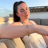 Thumbnail for Never Forget To Dream bracelet in gold worn during a relaxed moment | SKU: nftd-g