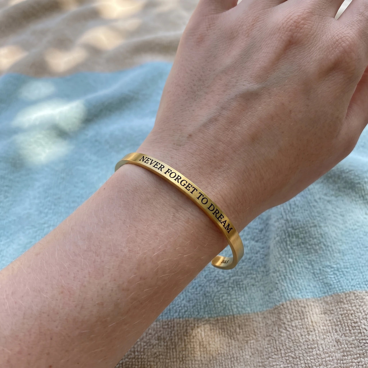 Never Forget To Dream bracelet in gold worn, showing its real size | SKU: nftd-g