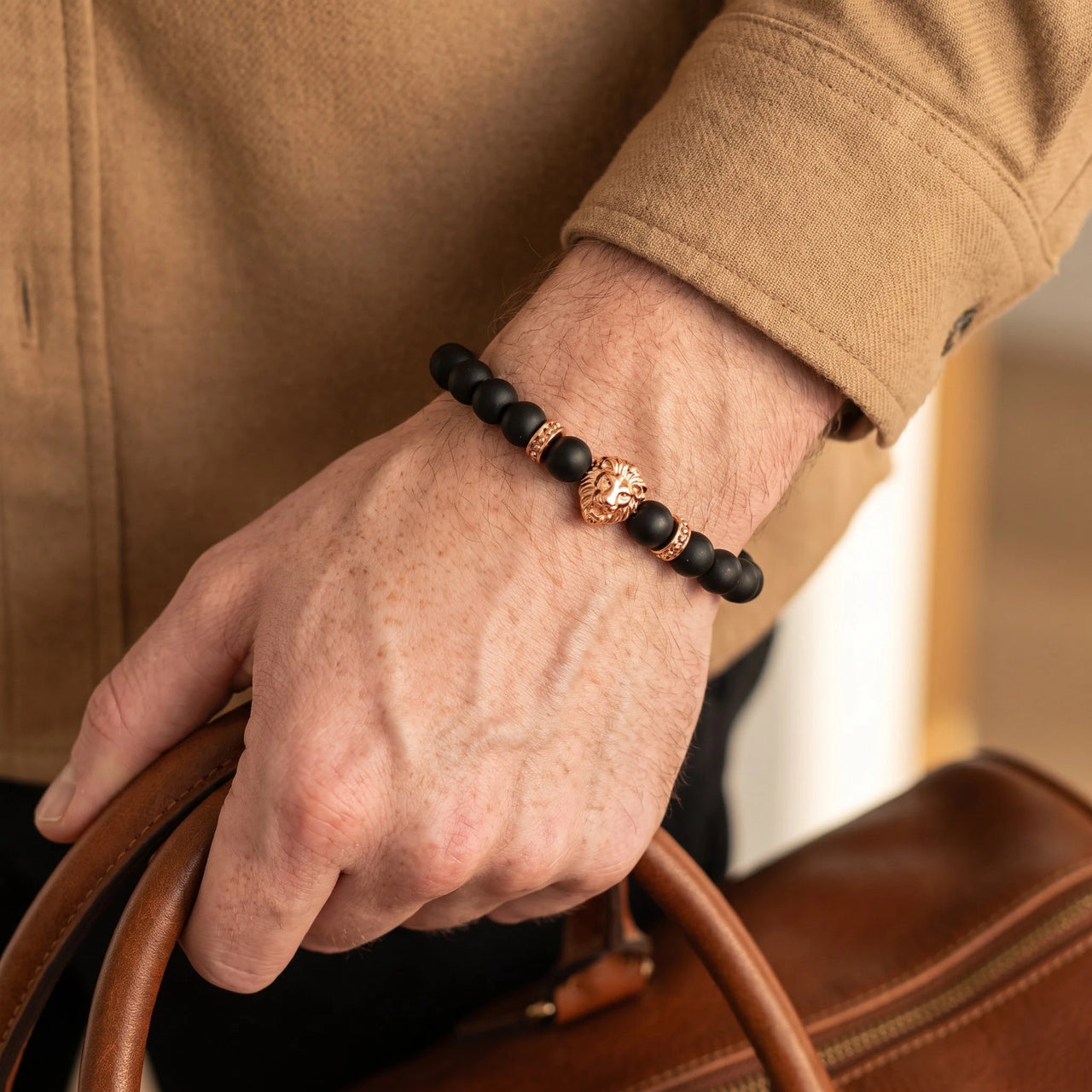 Rose Gold Lion & Black Stones Bracelet – close-up worn on a man's wrist | Brother & Sisters | SKU: 20712286-rose-gold-XS-14-15, 20712286-rose-gold-S-16-17, 20712286-rose-gold-M-18-19, 20712286-rose-gold-L-20-21, 20712286-rose-gold-XL-22-23