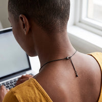 Thumbnail for Back of the neck at a laptop desk showing the clasp and extension chain of the black drop photo necklace | SKU: TPH-DRPN-BLACK
