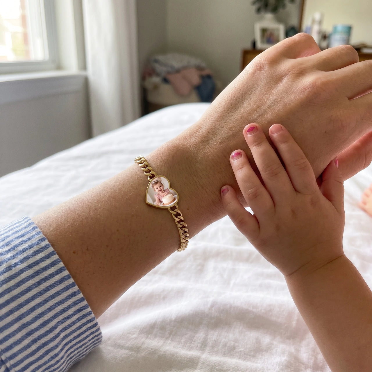 Mother and daughter hands together, the gold heart photo bracelet on the wrist | SKU: TPH-HRTB-GOLD