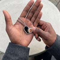 Thumbnail for Thumb warming the silver heart pendant: the hidden photo appears under the thumb while the rest stays black | SKU: TPH-HRTN-SILVER
